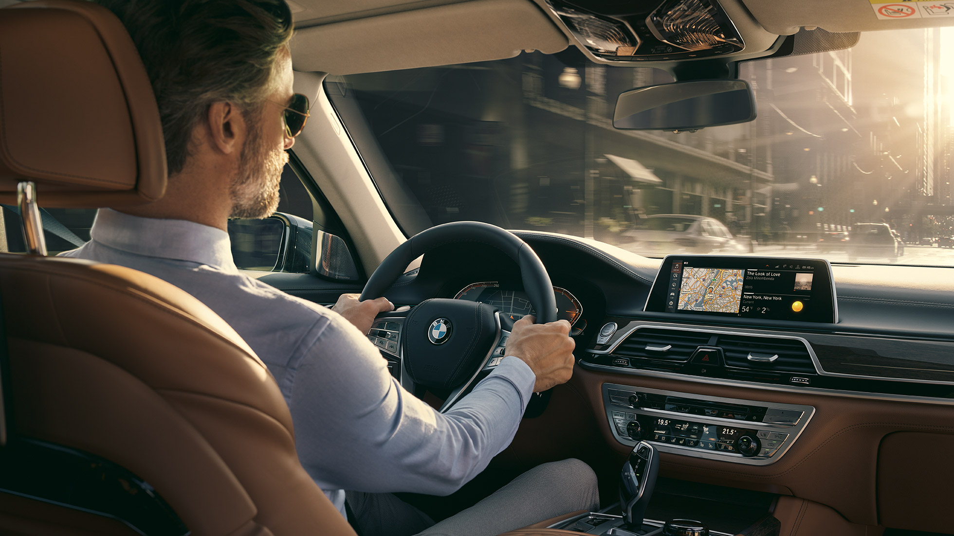 Funkcije povezljivosti v vozilu BMW serije 7 Limuzina BMW serije 7 Limuzina: voznik vozila BMW med uporabo funkcij povezljivosti
