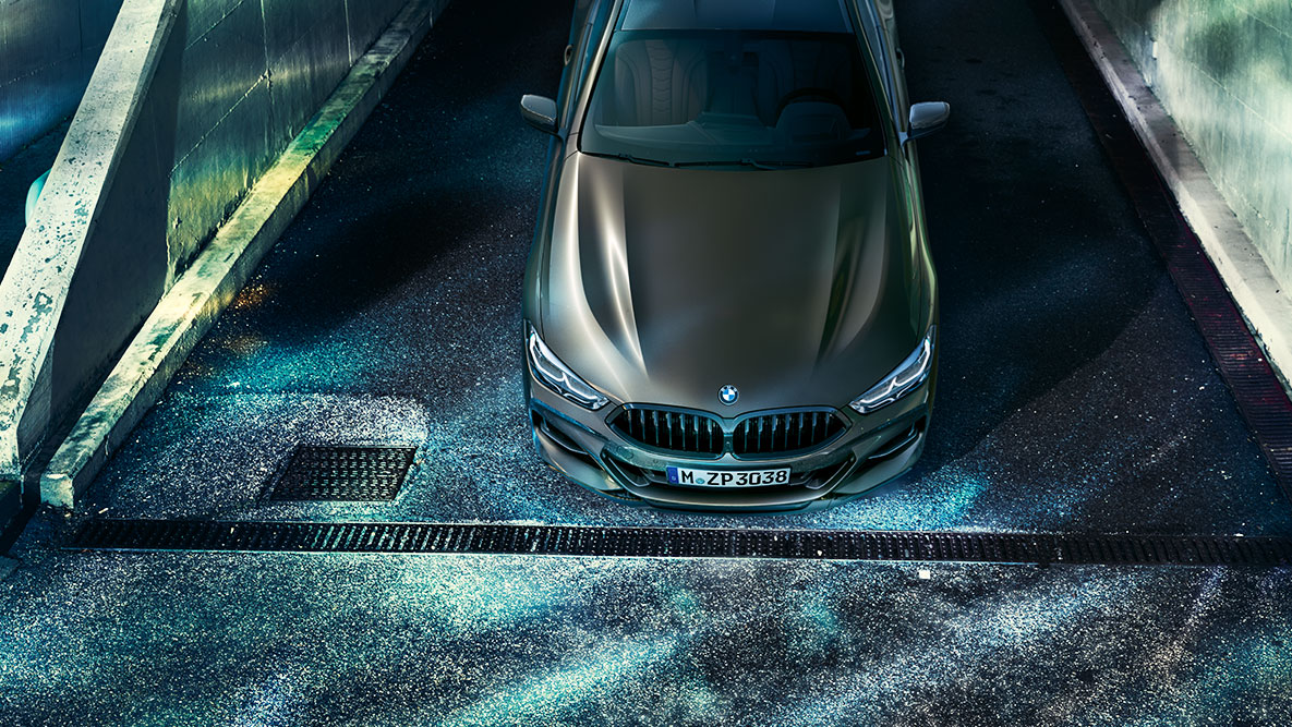 Mirujoč posnetek od spredaj BMW serije 8 Coupé. Mirujoč posnetek BMW serije 8 Coupé z opremo BMW Individual v mestnem okolju ponoči.