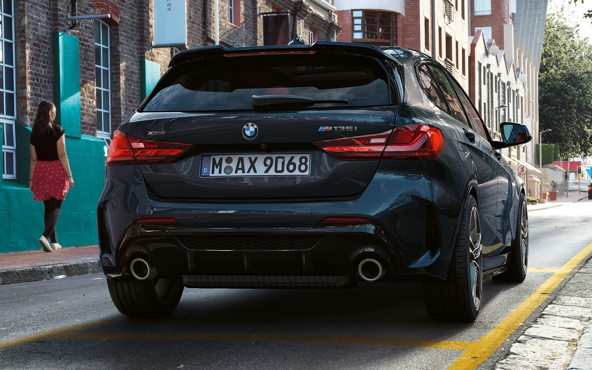 BMW M135i xDrive (F40), kovinska barva Black Sapphire, pogled od zadaj med parkiranjem
