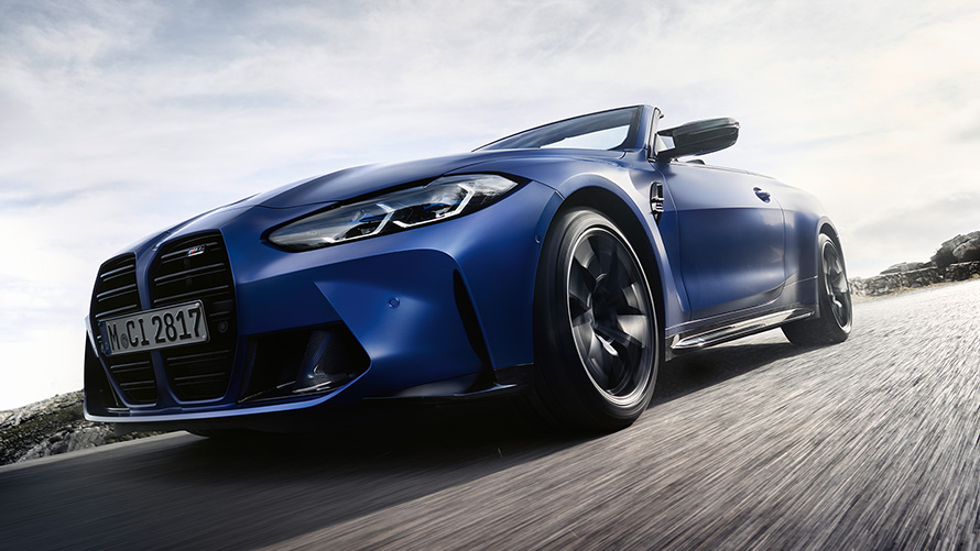 BMW M4 Competition Cabrio z M xDrive, G83, 2021, pogled od spredaj na dvojno ledvičko BMW M4 Competition Cabrio z M xDrive, G83, 2021, lakiranje BMW Individual v kovinski barvi Frozen Portimao Blue, ledvička, posnetek pod nizkim kotom