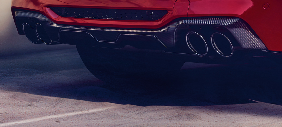 BMW X4 M Competition, karbonski zadnji difuzor. BMW X4 M Competition v kovinski barvi Toronto Red, zunanjost, paket zunanje opreme M Carbon, karbonski zadnji difuzor.