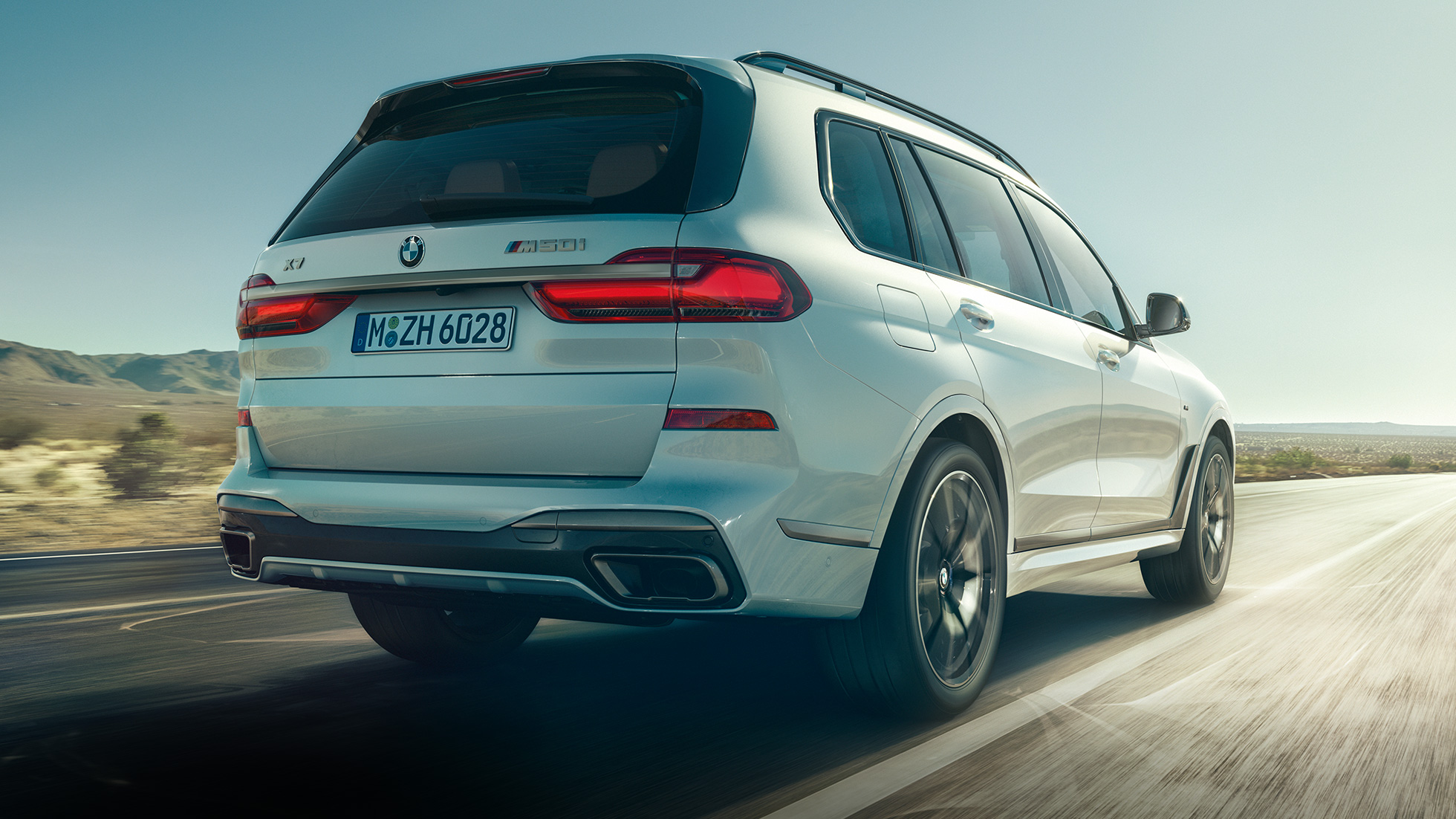 BMW X7 M50i, pogled od zadaj BMW X7 M50i v barvi Mineral White, med vožnjo, pogled od zadaj, G07, 2019