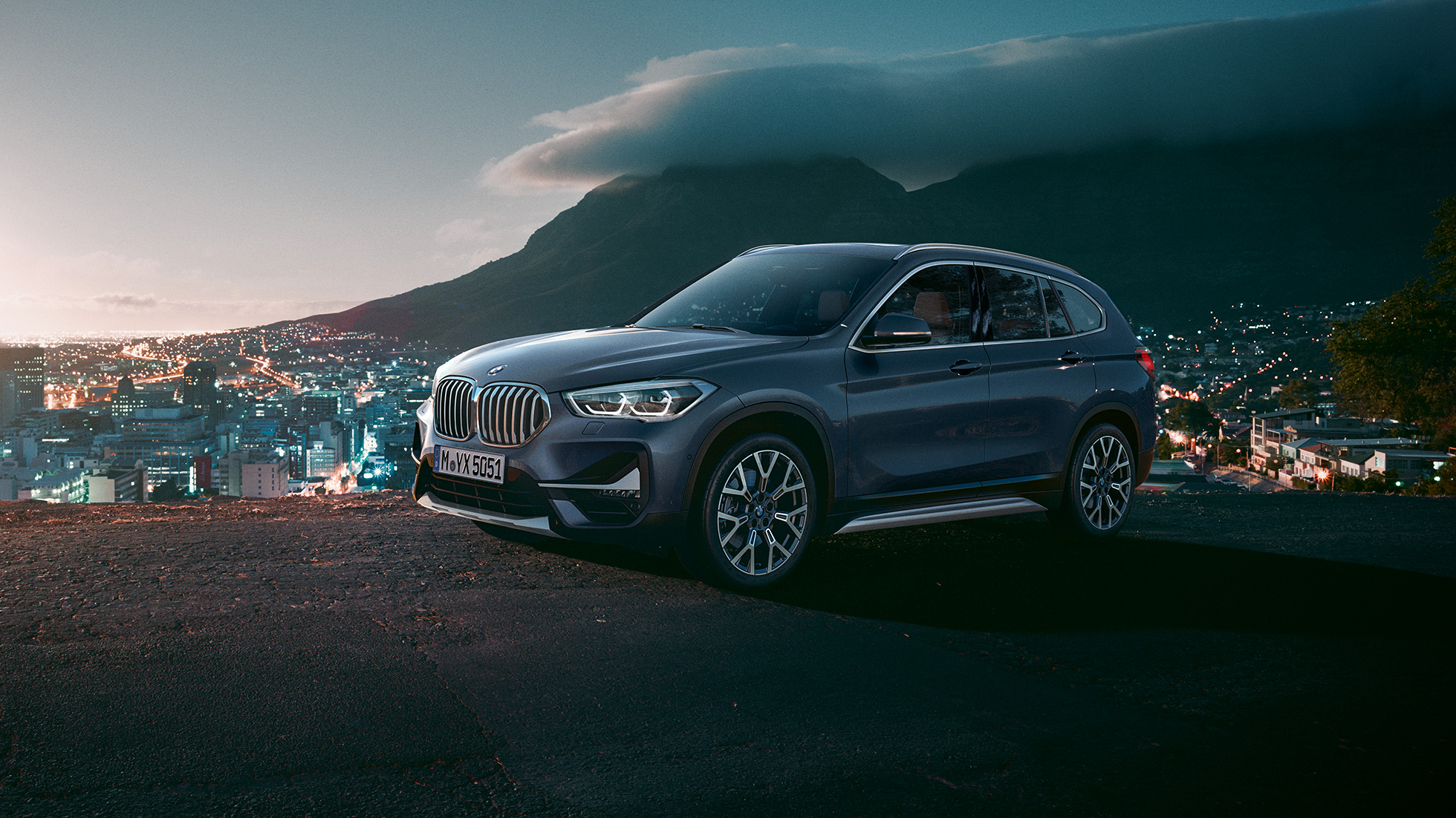 BMW X1, tričetrtinski stranski pogled. BMW X1, tričetrtinski stranski pogled, stoji pred mestno pokrajino.