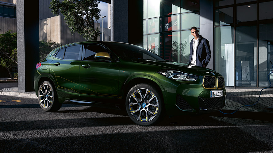 BMW X2, F39, kovinska barva Sanremo Green, tričetrtinski stranski pogled z manekenko BMW X2, F39, kovinska barva Sanremo Green, tričetrtinski stranski pogled z manekenko