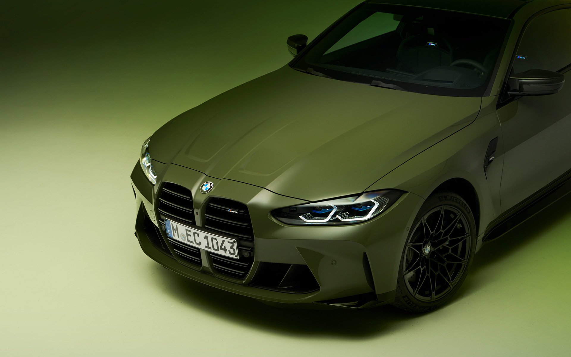 BMW M4 Competition Coupé, G82, 2021, BMW Individual ,Urban Green, tričetrtinski pogled od spredaj BMW M4 Competition Coupé, G82, 2021, BMW Individual ,Urban Green, tričetrtinski pogled od spredaj na odseku, pogled od zgoraj