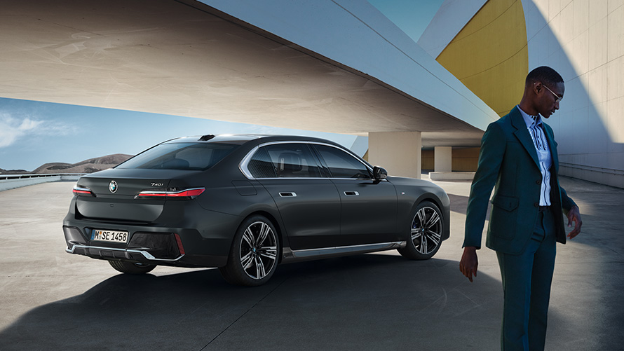 Diplomatska prodaja BMW, ugodnosti za diplomate Diplomatska prodaja BMW, ugodnosti za diplomate, moški stoji pred svojim diplomatskim vozilom BMW