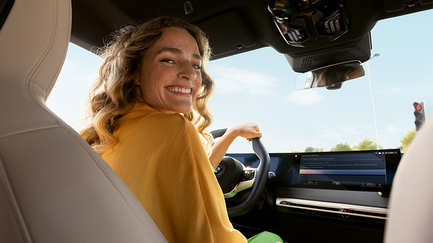 Funkcionalnost, Proactive Care, proaktivna nega, pregled in vzdrževanje Funkcionalnost, Proactive Care, proaktivna nega, pregled in vzdrževanje, ženska sedi v BMW z roko na volanu